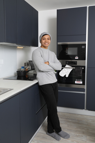 Srekanth Nilakantan stands in his kitchen